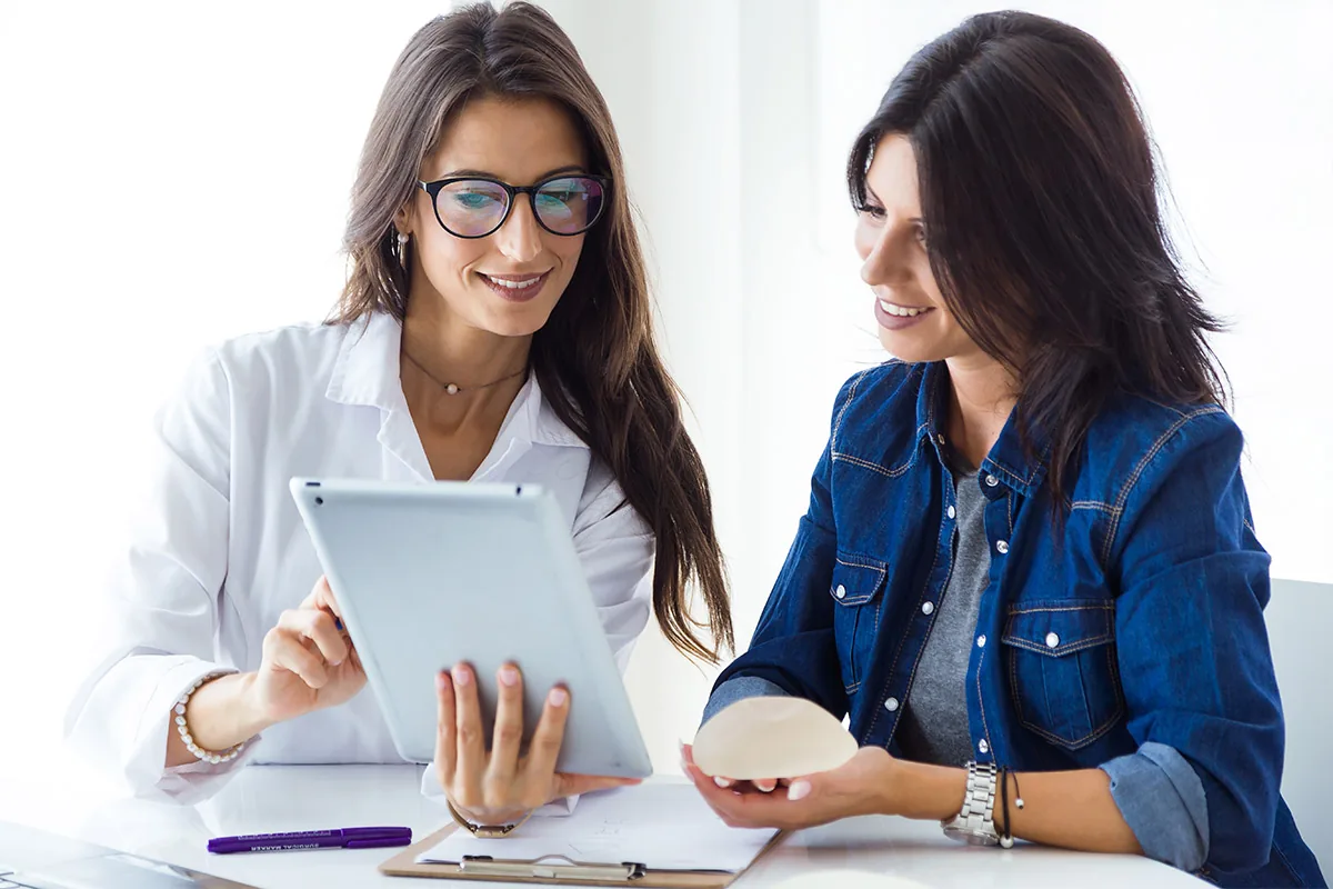 Care team member reviewing a tablet with a patient